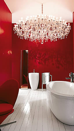 Striking Interior design of scarlet red bathroom with white plank flooring, Laufen sanitary wares & Panton Heart chair.